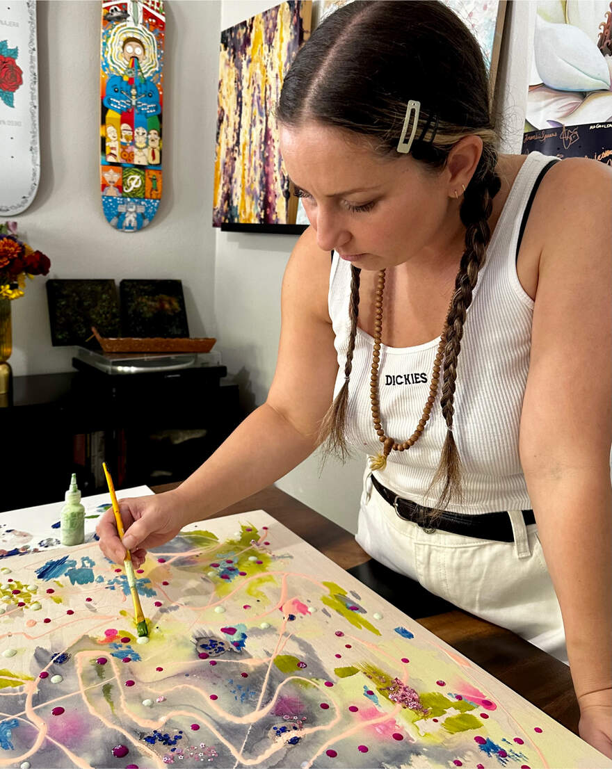 Female artist painting on a canvas